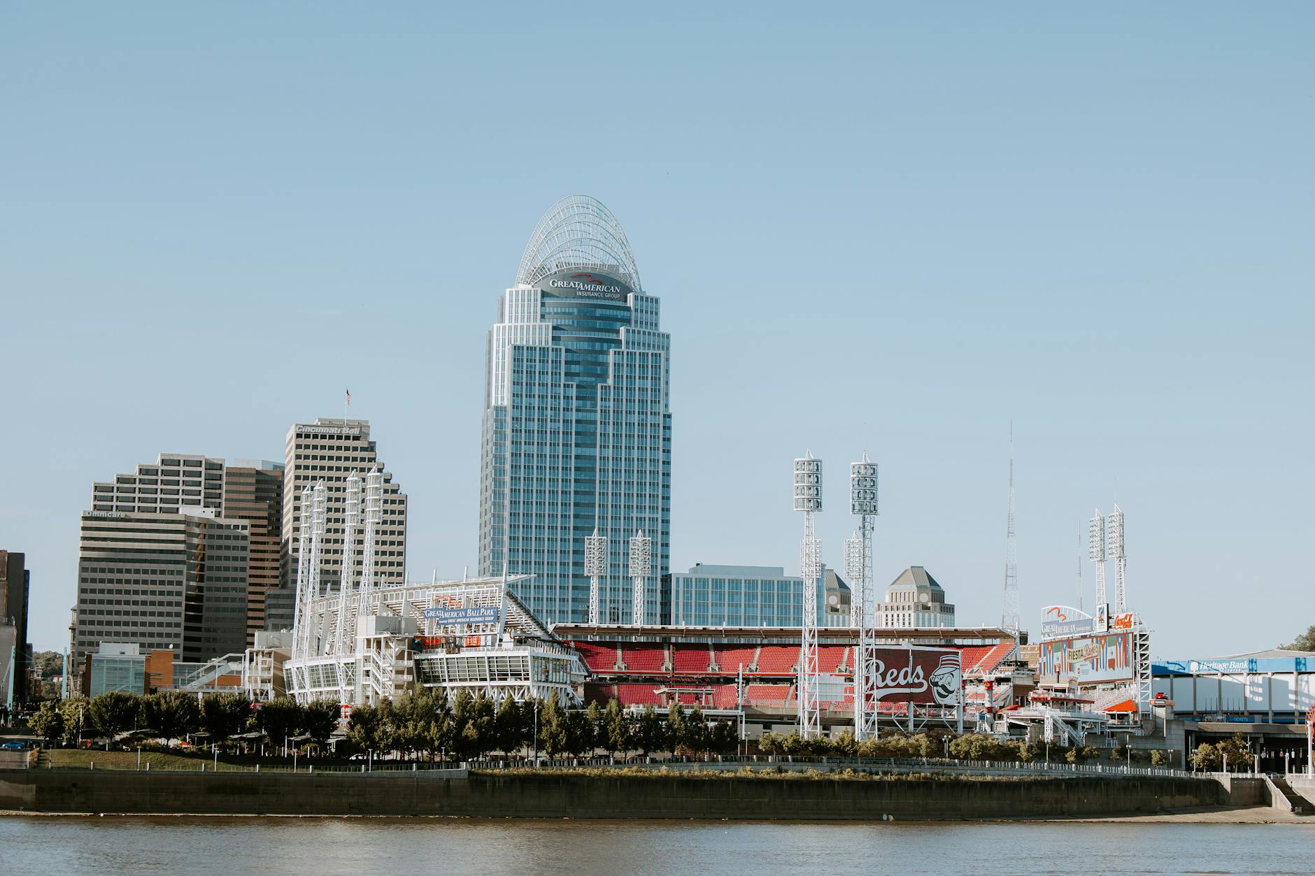 city buildings near body of water under blue sky