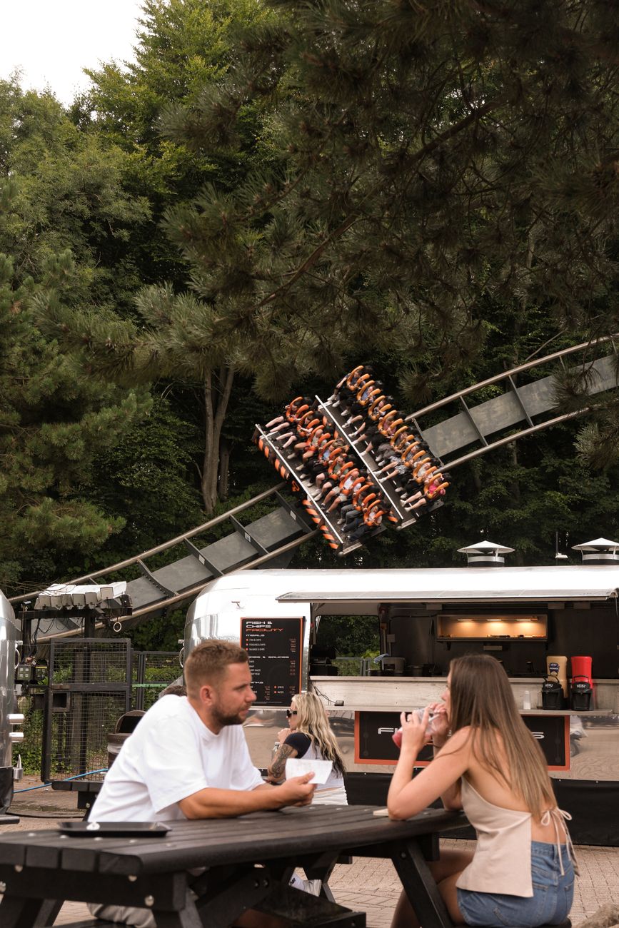 amusement park dining with roller coaster